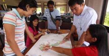 Local officials discuss the hazard map prepared by GGGI through the Ecotown Project in the Philippines.  The final report is available here (http://gggi.org/wp-content/uploads/2014/04/Eco_Town_Framework.pdf) Image Credit: Global Green Growth Institute (GGGI)