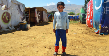 A refugee child in the camp at Qab Elias, Bekaa Valley, Lebanon, near the Syrian border. Image Credit: Flickr (CAFOD Photo Library) Creative Commons.