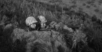 Two soldiers in a foxhole during the Korean war. Photo Credit: Flickr (Morning Calm Weekly Newspaper) Creative Commons.