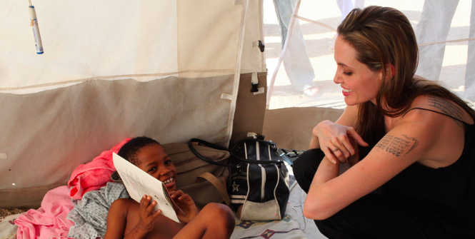 Angelina Jolie visits a boy who lost a limb in the Haitian earthquake. Photo Credit: Flickr (UNHCR UN Refugee Agency) Creative Commons.