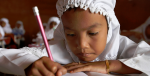 Schoolchildren write at their desk at a school in Indonesia. Photo Credit: Flickr (DFATD | MAECD) Creative Commons