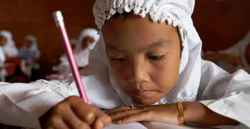 Schoolchildren write at their desk at a school in Indonesia. Photo Credit: Flickr (DFATD | MAECD) Creative Commons