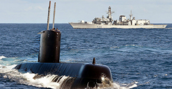 South African Navy submarine SAS Charlotte Maxeke cuts through the surface ahead of Type 23 frigate HMS Portland during an exercise off the coast of South Africa. Photo Credit: Flickr (Defence Images) Creative Commons