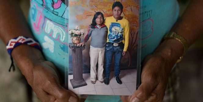 Elsa, an indigenous woman from the Chocó department, holds a photo of her reunion with her son. The ICRC helped them re-establish contact with each other after ten years without news. Colombia.  ICRC/Juan Arredondo 