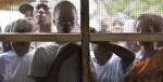 Young Liberians listen outside a women’s peace hut in Totoa, Bong County, Liberia. 7 March 2011. Photo Source: UN Photo/Staton Winter.