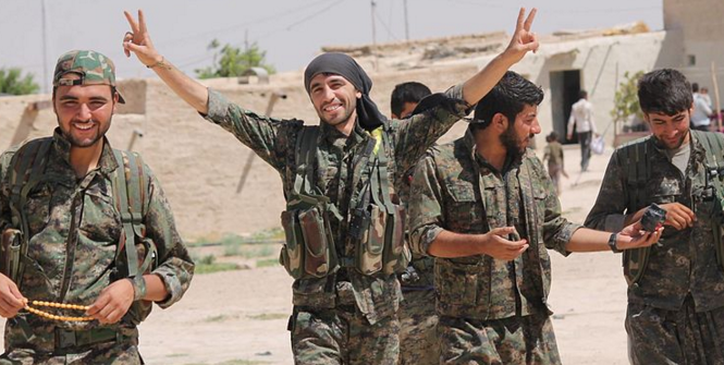 YPG fighters walking back to base celebrating from a victory. August 2015. Photo Source: Wikimedia (Flickr). Creative Commons.