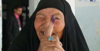 Female voters display their purple finger tips after casting ballots at an elementary school in Nasiriyah March 7. By law, women must fill 25percent -- 82 out of the 325 -- parliamentary seats. The heavy purple dye reduces attempts of double-voting fraud. No election day violence occurred in Nasiriyah, Iraq's fourth largest city bisected by the Euphrates River in the southern province of Dhi Qar. Iraqi security forces were responsible for all security.