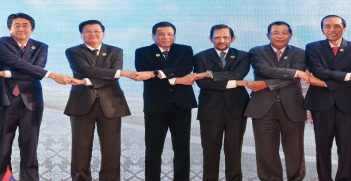 Indonesian Prime Minister Joko Widodo holding hands with other ASEAN leaders