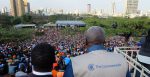 An international observer looks over a crowd gathered for the 2017 Kenya election.