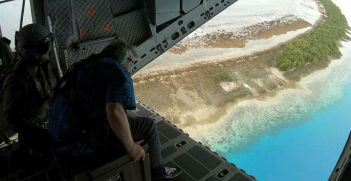 UN Secretary General Antonio Guterres surveys Tuvalu from an RAAF plane. Source: Australian Department of Defence