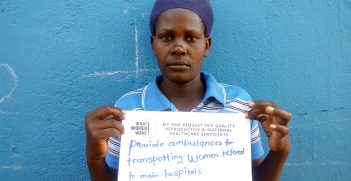 Woman holding a sign saying 