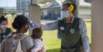 Kamala Jones administers a temperature check on a parent at the Center Drive Child Development Center on Joint Base Pearl Harbor-Hickam. Source: U.S. Navy photo by Mass Communication Specialist 2nd Class Charles Oki https://bit.ly/3cVzroY