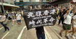 A protester holds a sign saying 