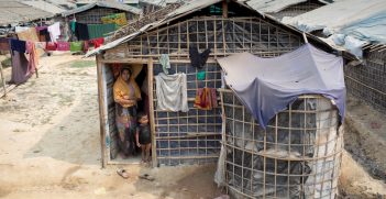 A refugee mother with her child in front of her bamboo and plastic shelter at Jadimura settlement. Source: European Union https://bit.ly/3mS3nb9